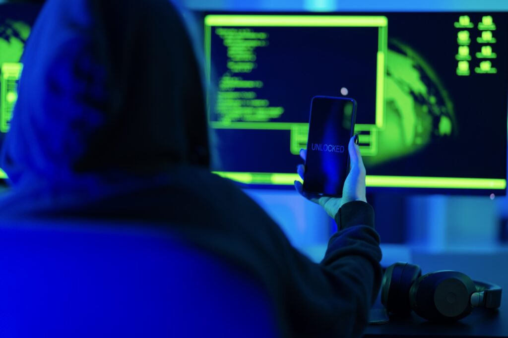 Anonymous mobile cyber security hacker break into and unlock phone to steal company or private data